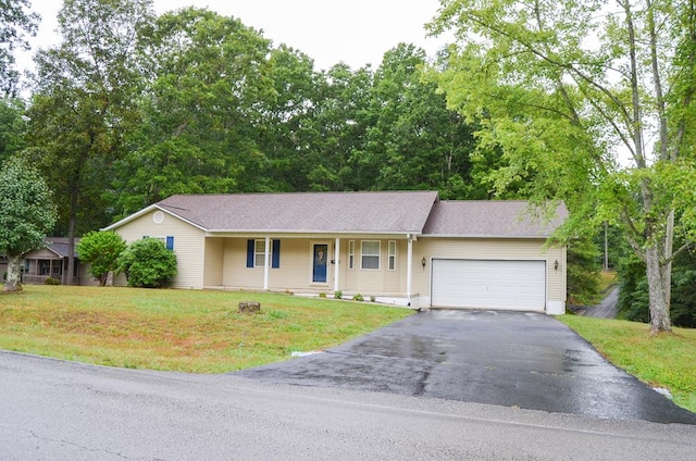 ranch-style home with a garage, driveway, and a front lawn