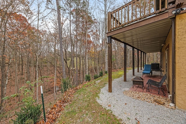 view of yard with central AC unit and a deck