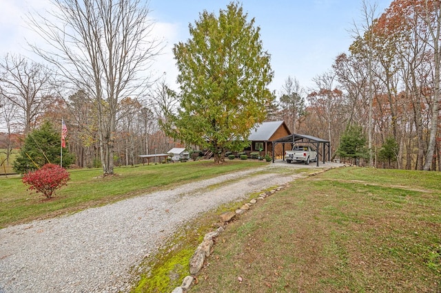 view of front of home with a front yard, gravel driveway, and an attached carport