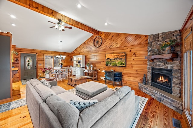 living area with vaulted ceiling with beams, light wood finished floors, and visible vents