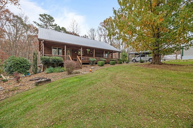 view of front of home with metal roof, a porch, and a front lawn