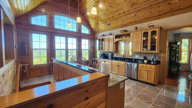 kitchen featuring wood ceiling, stainless steel dishwasher, glass insert cabinets, and pendant lighting