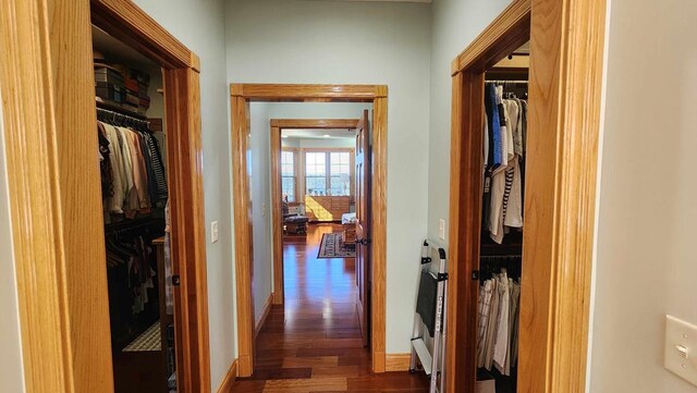 hallway with dark wood-style floors and baseboards