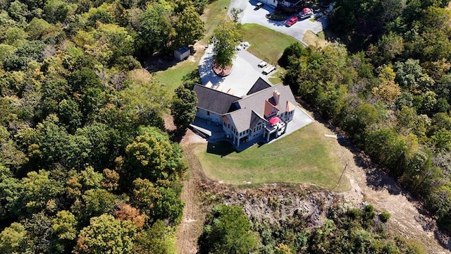 birds eye view of property with a wooded view