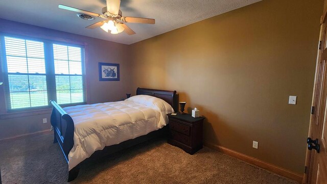 bedroom with ceiling fan, baseboards, and dark colored carpet