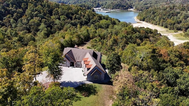 aerial view featuring a water view and a view of trees