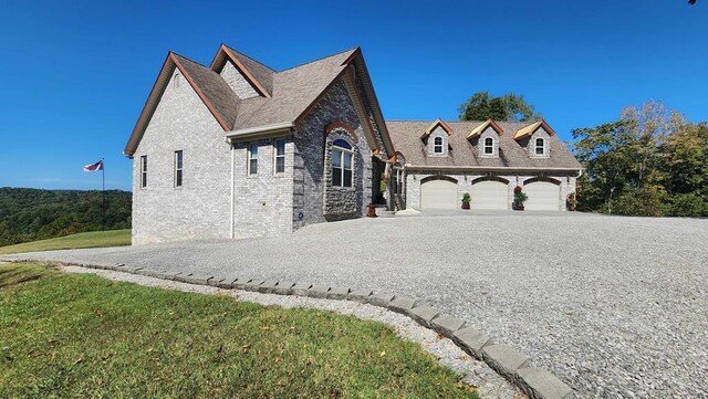 view of front of property with driveway, a front lawn, and brick siding