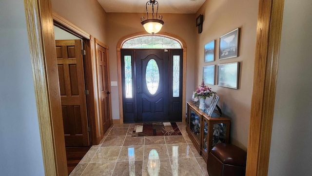 foyer entrance featuring marble finish floor