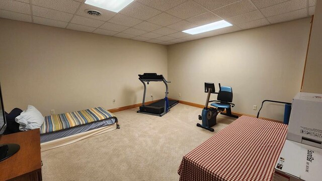 workout room with carpet floors, a paneled ceiling, visible vents, and baseboards