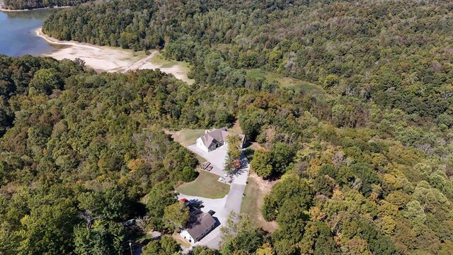 aerial view with a water view and a wooded view