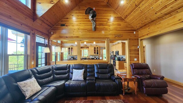 living area with high vaulted ceiling, wooden ceiling, wood walls, and wood finished floors