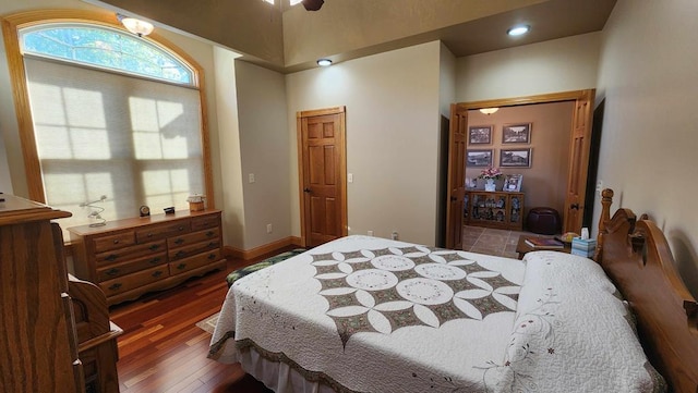 bedroom featuring dark wood finished floors and baseboards