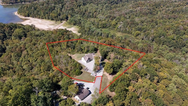 drone / aerial view featuring a water view and a view of trees