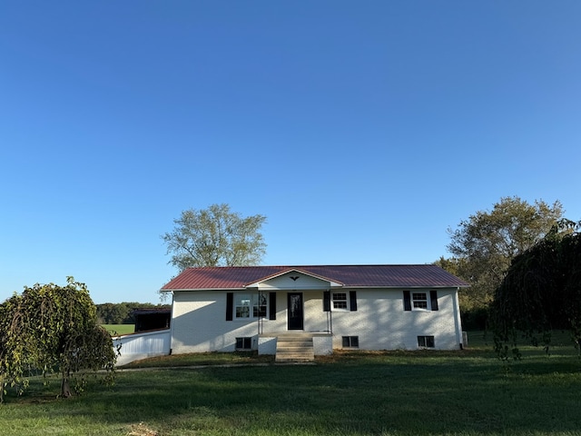 single story home with a front lawn, metal roof, and central AC