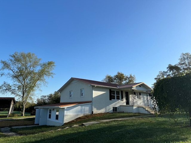 exterior space featuring covered porch, brick siding, and a front lawn