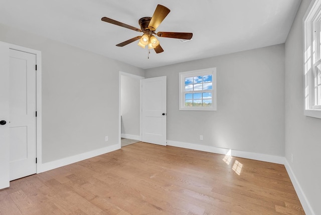 unfurnished bedroom featuring light wood-style floors, baseboards, and a ceiling fan