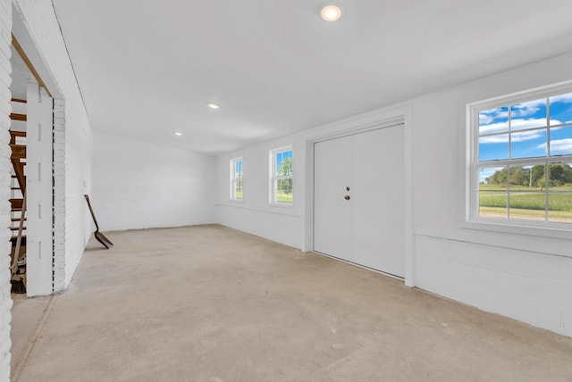 unfurnished living room featuring concrete flooring