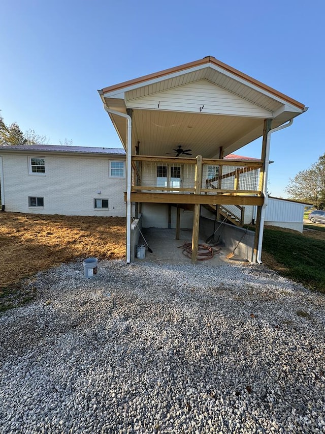 back of house featuring a ceiling fan, a patio area, and a wooden deck