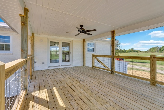 wooden deck featuring a rural view and a ceiling fan