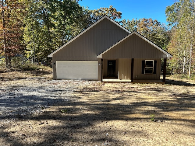 chalet / cabin with a garage and driveway