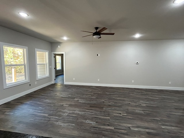 spare room featuring ceiling fan, recessed lighting, dark wood finished floors, and baseboards