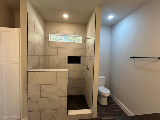 full bathroom featuring recessed lighting, toilet, wood finished floors, baseboards, and a walk in shower