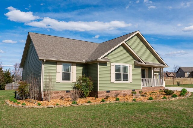view of front of home with a front yard, crawl space, and fence