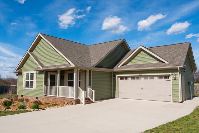 view of front of home featuring an attached garage, covered porch, a shingled roof, and concrete driveway