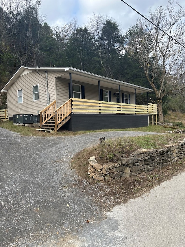 manufactured / mobile home with stairs and a porch