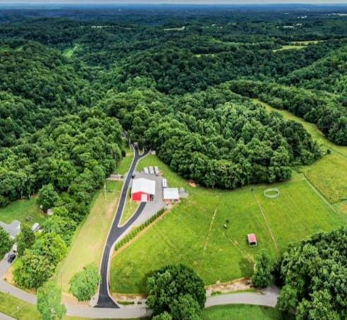 birds eye view of property featuring a forest view