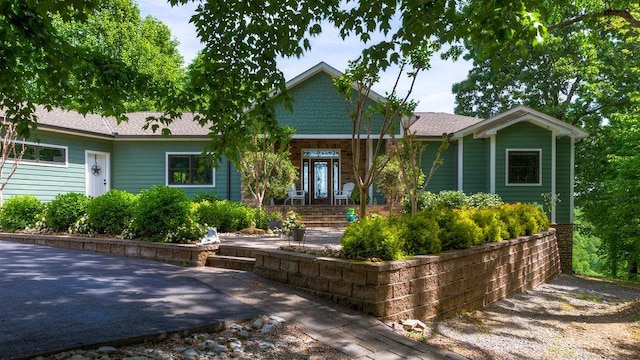 single story home featuring stone siding