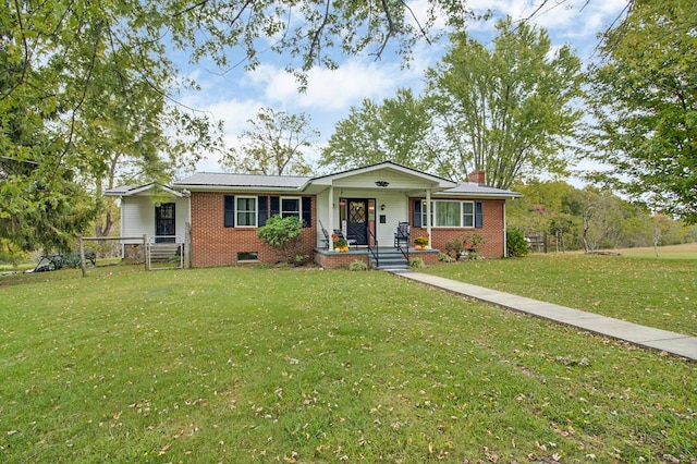 ranch-style house featuring brick siding, a chimney, fence, a porch, and a front yard