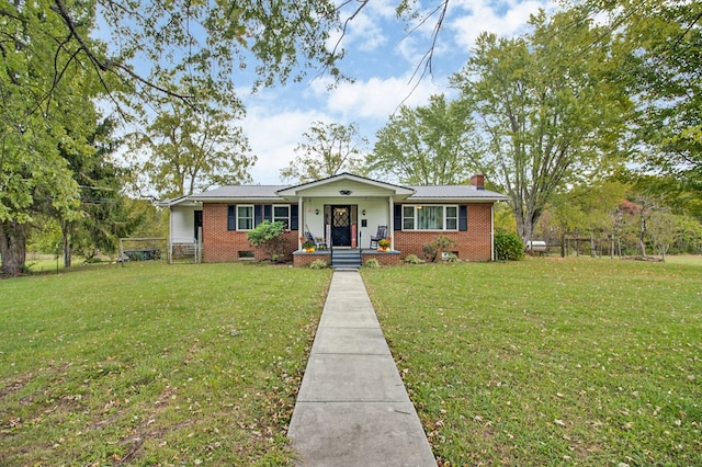 view of front of house with crawl space, a chimney, a front lawn, and brick siding