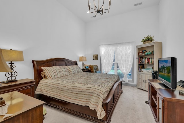 bedroom featuring light carpet, access to exterior, visible vents, and a notable chandelier