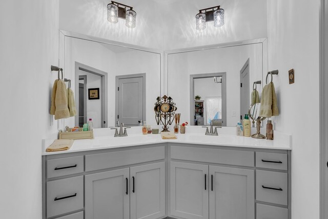 ensuite bathroom featuring ensuite bathroom, double vanity, and a sink