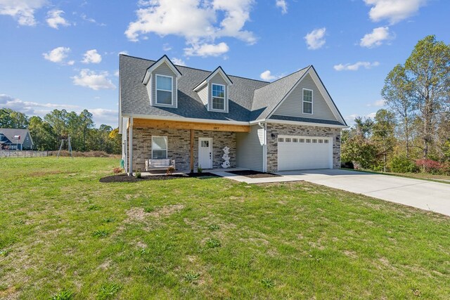 view of front of house with driveway, a shingled roof, and a front yard