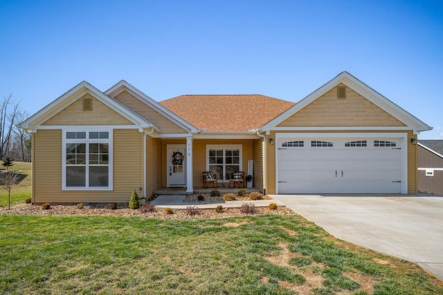 view of front of house with a porch, driveway, a front lawn, and a garage