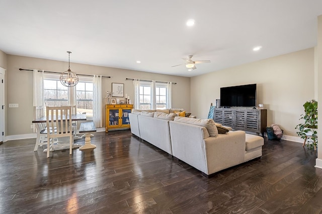 living area with ceiling fan with notable chandelier, recessed lighting, dark wood-style floors, and baseboards