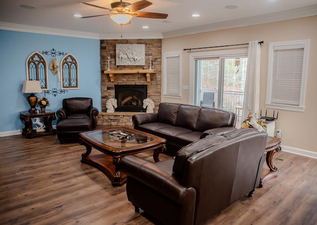 living room with ornamental molding, a fireplace, wood finished floors, and baseboards