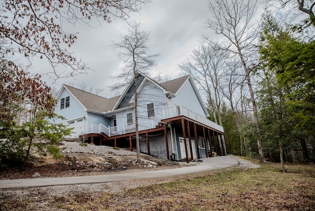 view of home's exterior with a deck and an attached garage