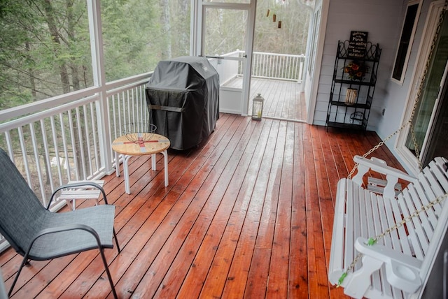 wooden deck with a grill