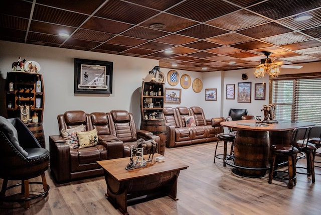 living area with ceiling fan and wood finished floors