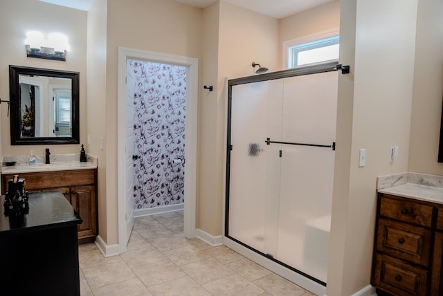 full bath featuring tile patterned flooring, a shower stall, vanity, and baseboards