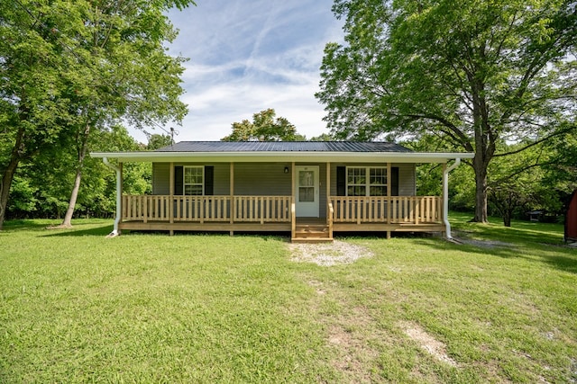 view of front of home with a porch, metal roof, and a front lawn