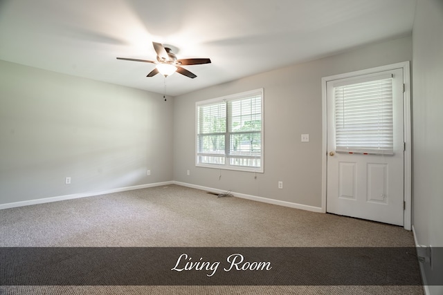 carpeted empty room with ceiling fan and baseboards