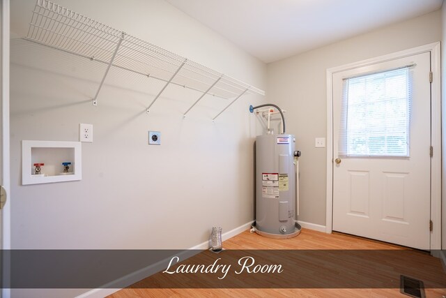 utility room featuring visible vents and electric water heater