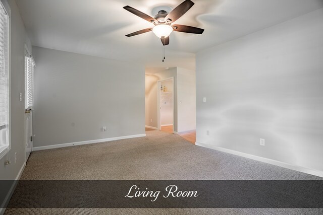 unfurnished room with light carpet, baseboards, and a ceiling fan