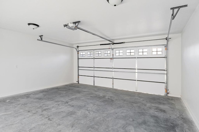 garage featuring baseboards and a garage door opener