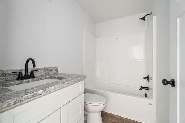 full bathroom featuring toilet, shower / bathing tub combination, wood finished floors, and vanity