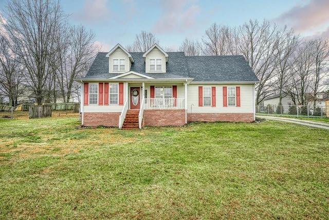 cape cod home featuring a porch, roof with shingles, fence, and a front lawn